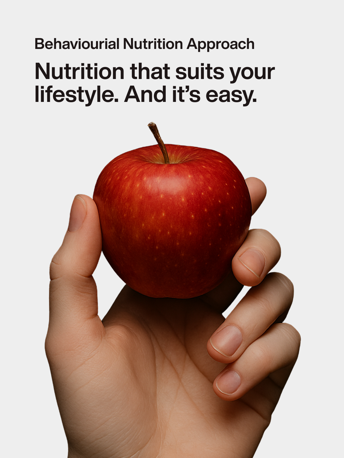 Hand holding a red apple to represent an easy, lifestyle-based behavioral nutrition approach